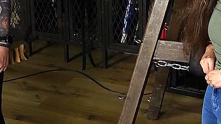 Slave Mila's Feet Dangle and Quiver as Mistress Baton Breaks in Heavy Wooden Paddle Over Her Jeans and Bare