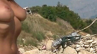 Stunning Brunette Babe Strips Naked on Rocky Beach Adventure