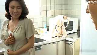 Japanese mom masturbated in the kitchen when her boy came in