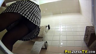 Asian slut pees in toilet