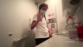 Brunette Pissing in Public Toilet