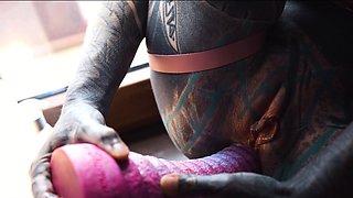 Gorgeous tattooed girl fucks her ass with a big dildo