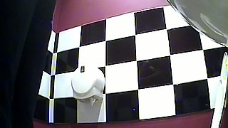 Slender and young blonde girl in the public toilet room pisses