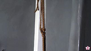 Hanging by Her Ankles From Rope Bondage, Slave Mila Can't Escape the Wand Attached to Her Swollen Pussy