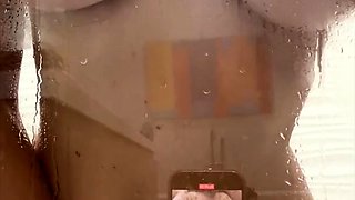 Busty vixen poses naked and plays with herself in the shower