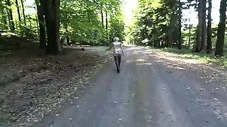 Lonely slave in fetish clothes walking in the woods