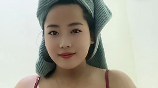 Young mommy looking beautiful after a shower, squeezing her big tits.