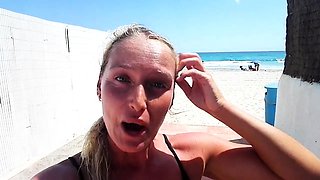 Outdoor solo masturbation scene with curly blonde