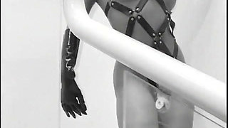 Two guys wearing masks get their large cocks sucked by a hot chick in latex gear